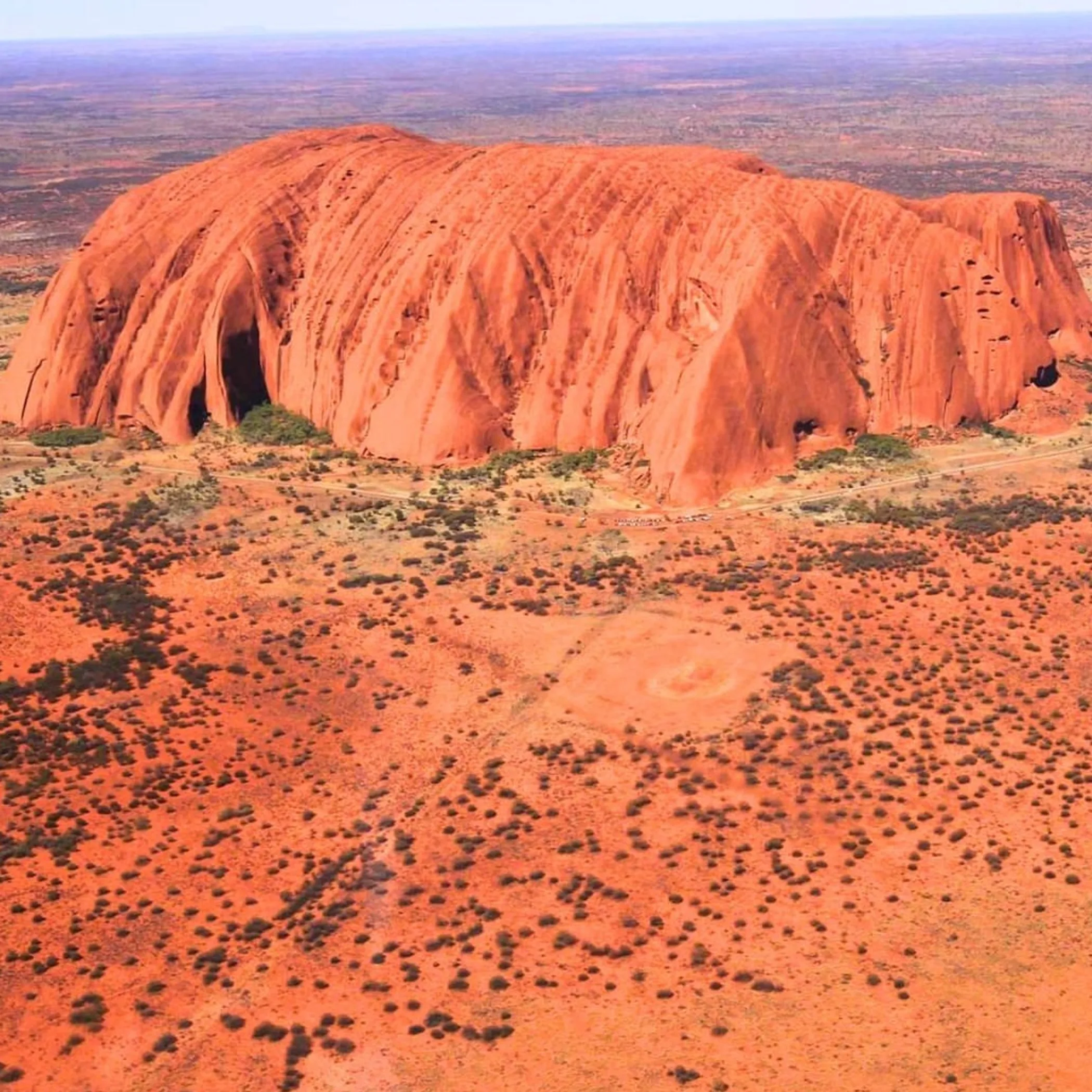 uluru rock formation under clear sky